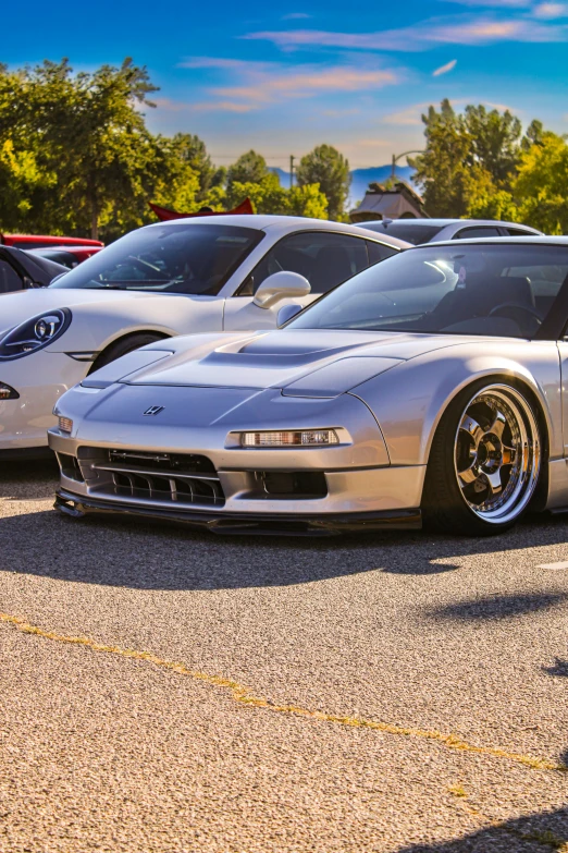 several cars parked in a lot in the sun