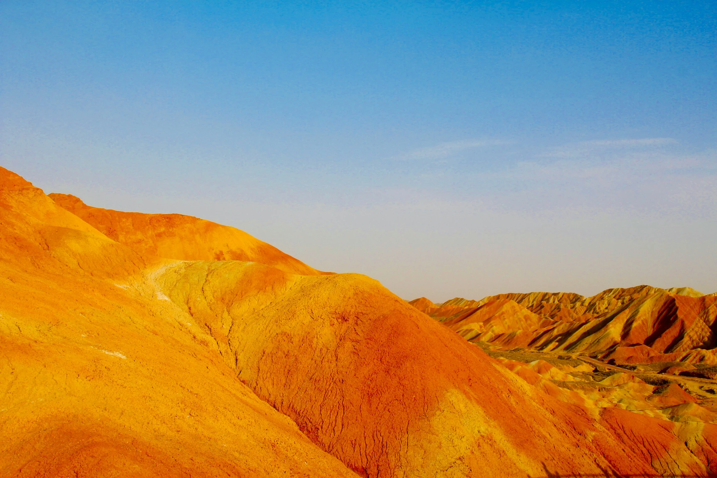 colorful hills that appear to be painted with yellow and orange