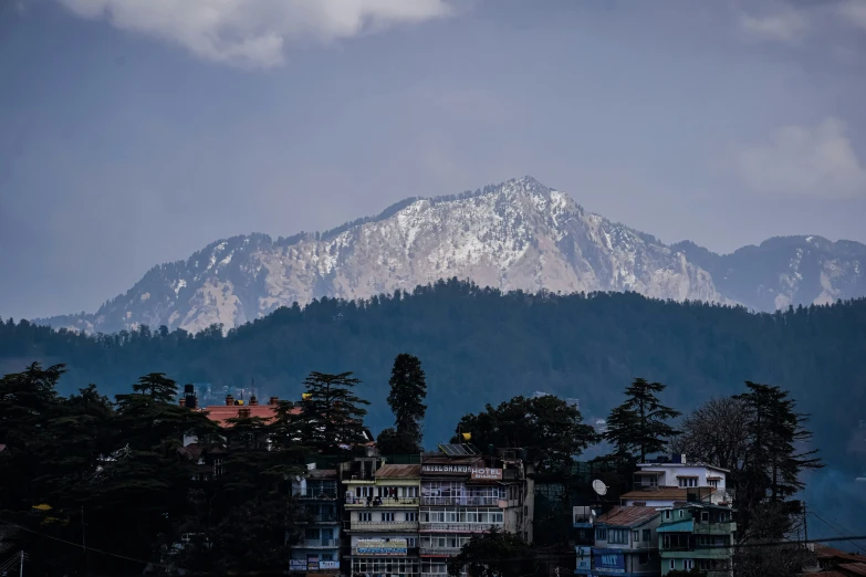 a view of a town in front of mountains