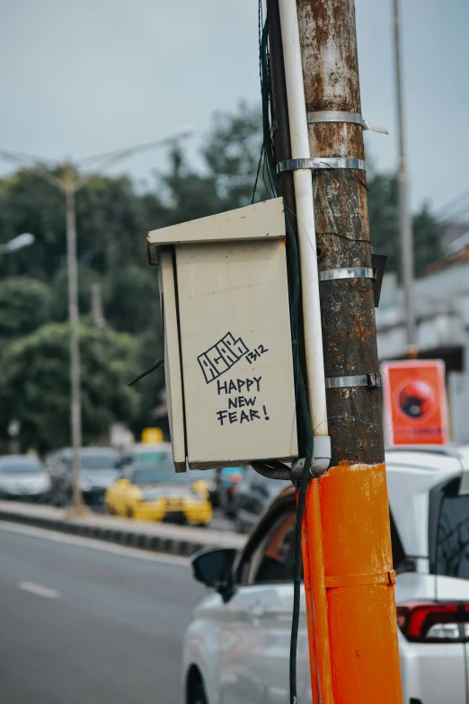 a street sign on a metal pole next to a white car