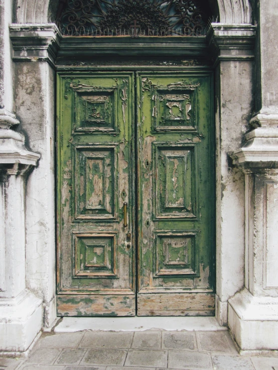 large doors sitting next to each other in an ornate setting