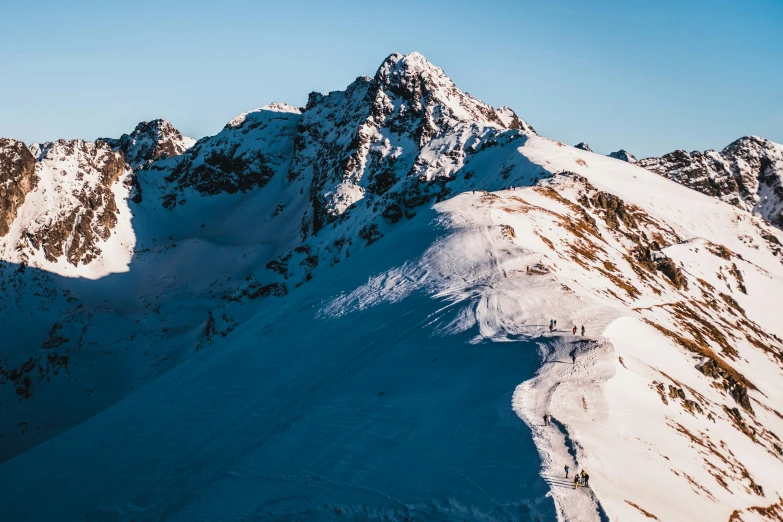 snow - capped mountain tops against a blue sky