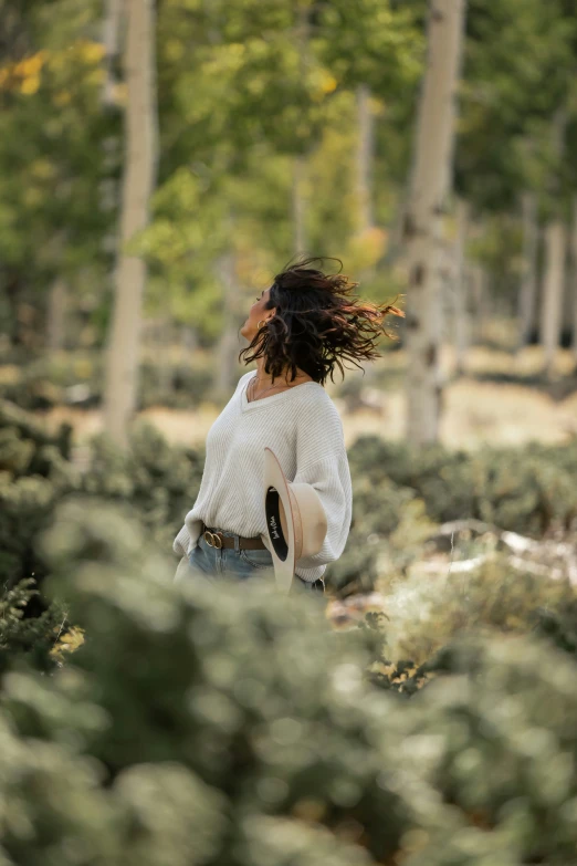 a woman that is walking in the grass