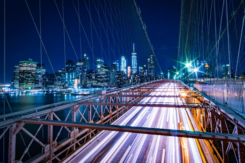 a night s from a bridge that has light trails on it