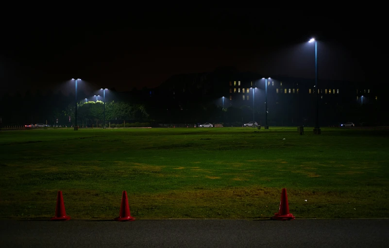 the lights shine in the background above the field