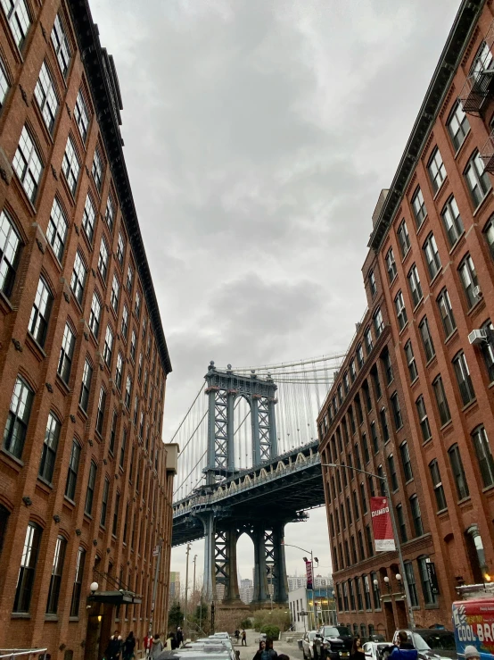 an image of people walking near a bridge