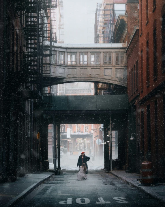 an image of man walking down a wet street in the rain