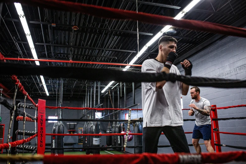 three guys in a gym talking to each other