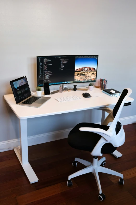 a white desk with black chair and a lap top computer