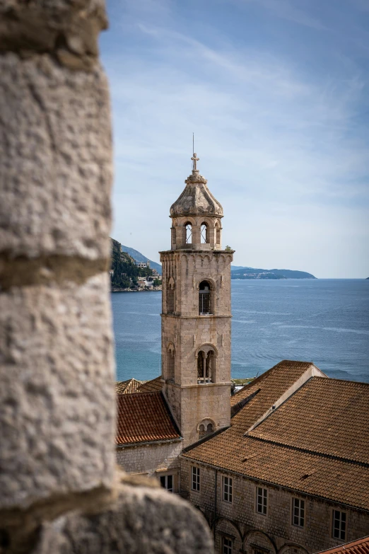 a view of some water and buildings with a clock tower in the middle