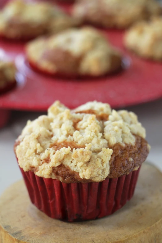 close up view of a muffin with crumbs on the top