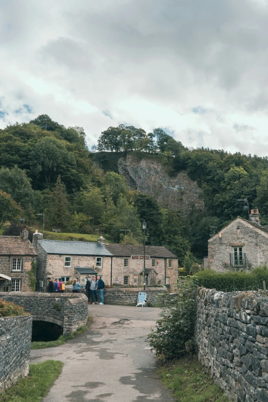 two old houses with stone walls and a walkway leading up to it