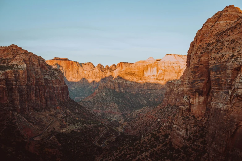 the sun is setting on the mountains behind a group of trees