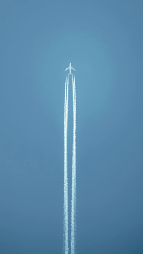 an airplane in the sky going straight upward