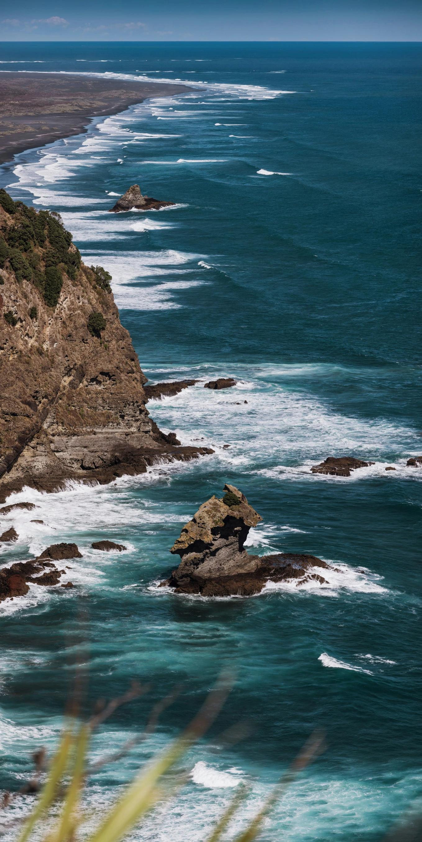 some water waves and some rocks are by the beach