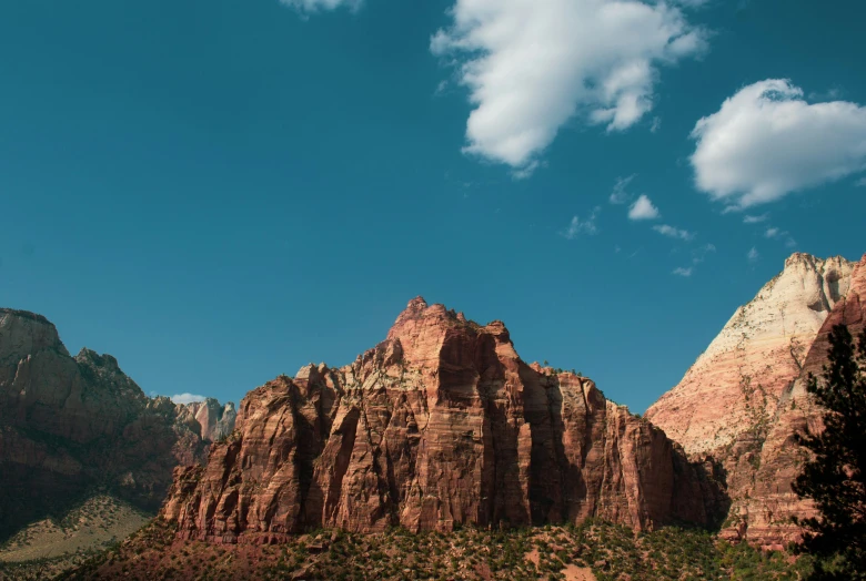 mountains under blue skies with white clouds