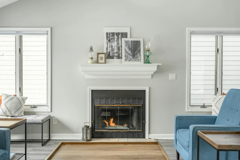 a living room filled with blue couches next to a fire place