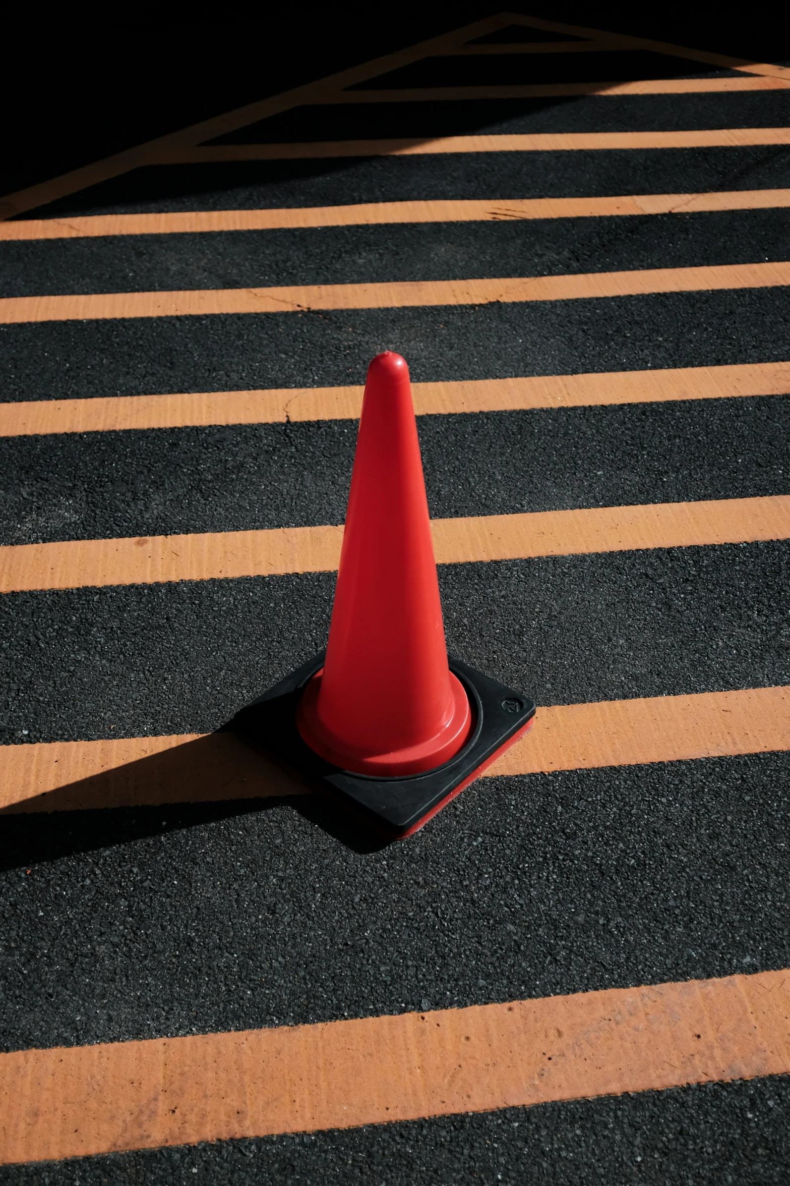 a traffic cone on the ground near a street