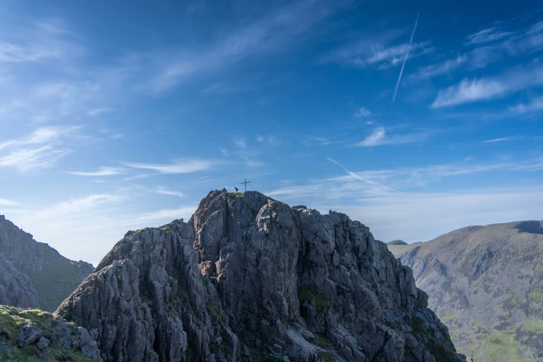 a couple of mountains that have people standing on them