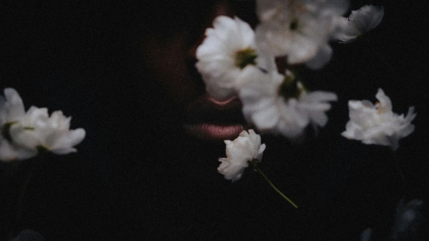 a person with some flowers in their hand