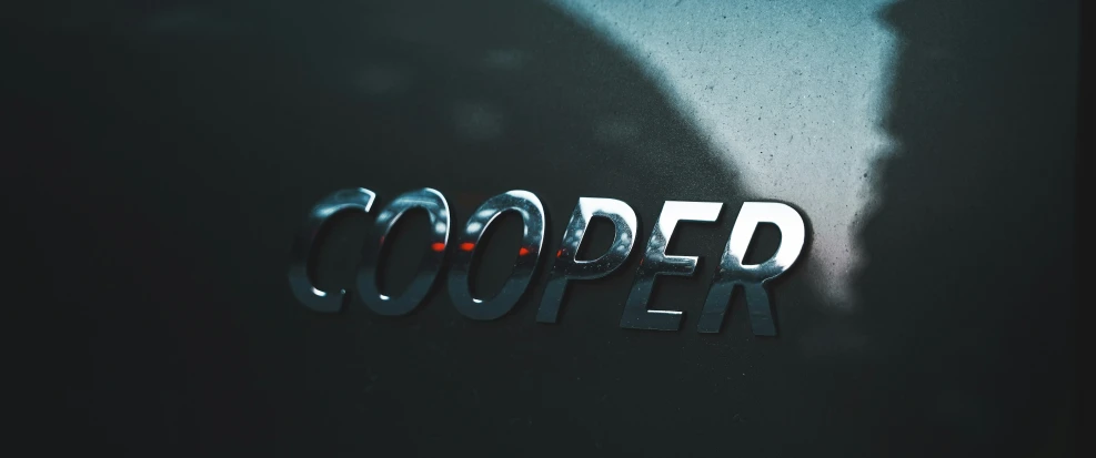 the emblem on the back of a black car that says,'couper '