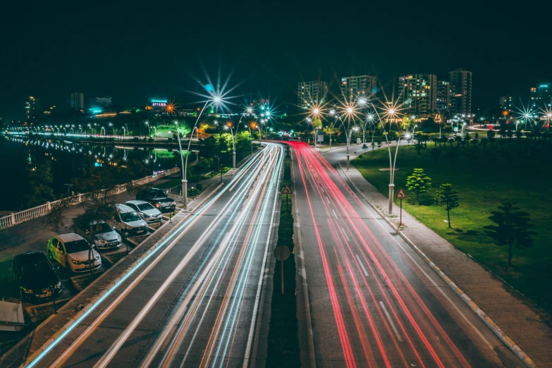 light trails are shining as cars drive on the road