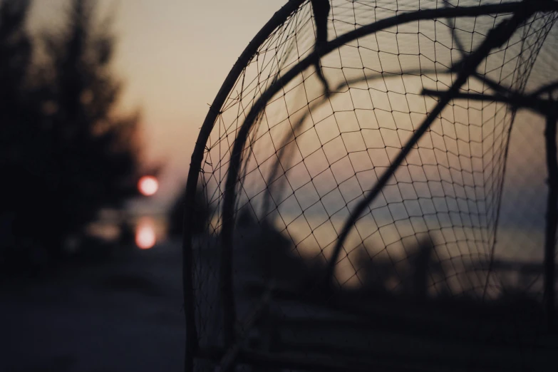 this is the image of a netting with a car in the background