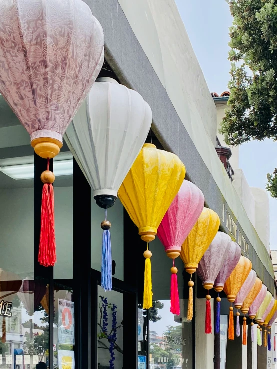 a row of brightly colored lanterns hanging from the side of a building