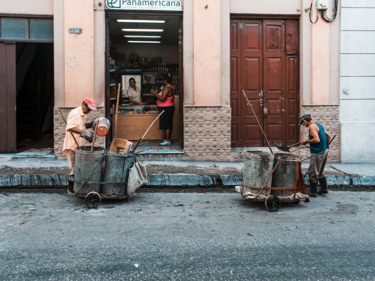 a couple of women with various things standing outside of a shop