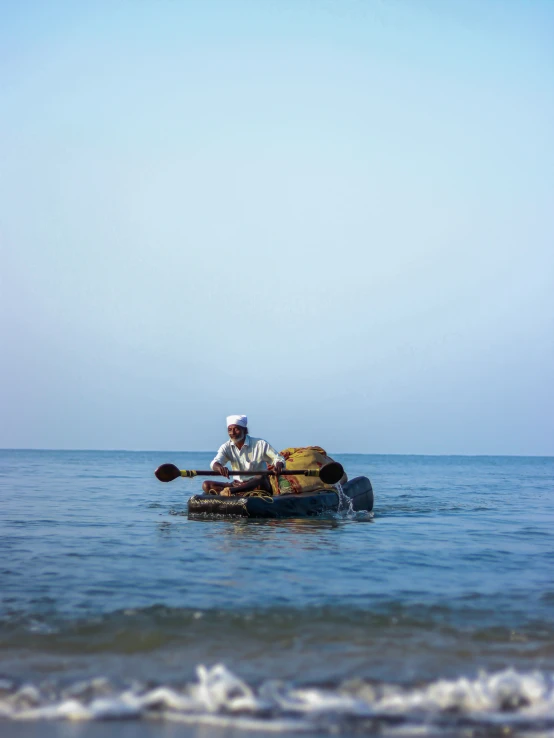 man in a canoe paddling on a clear day