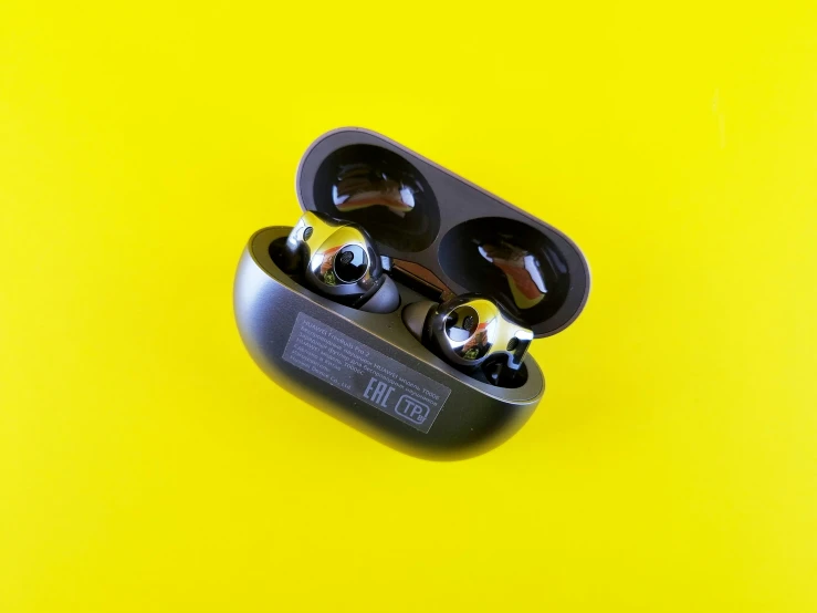 two earphones on top of a yellow background