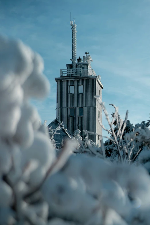 a very tall building covered in snow with a sky background