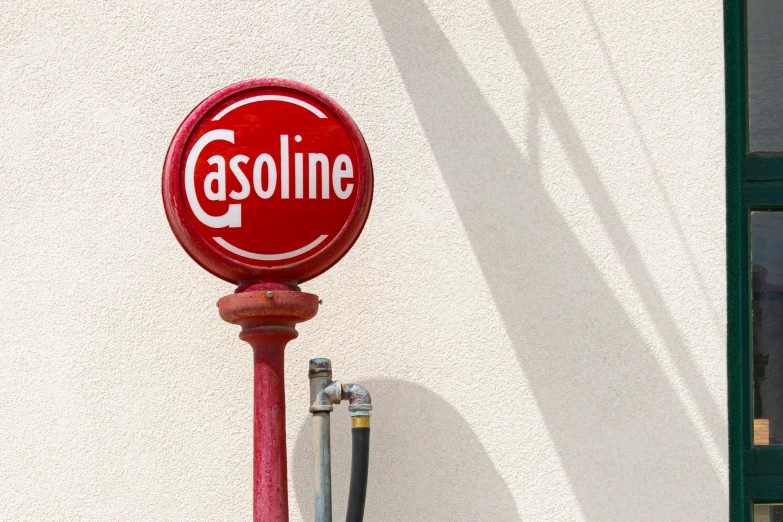 a gas pump with a gasoline sign on top