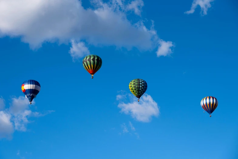 several colorful balloons are flying in the sky