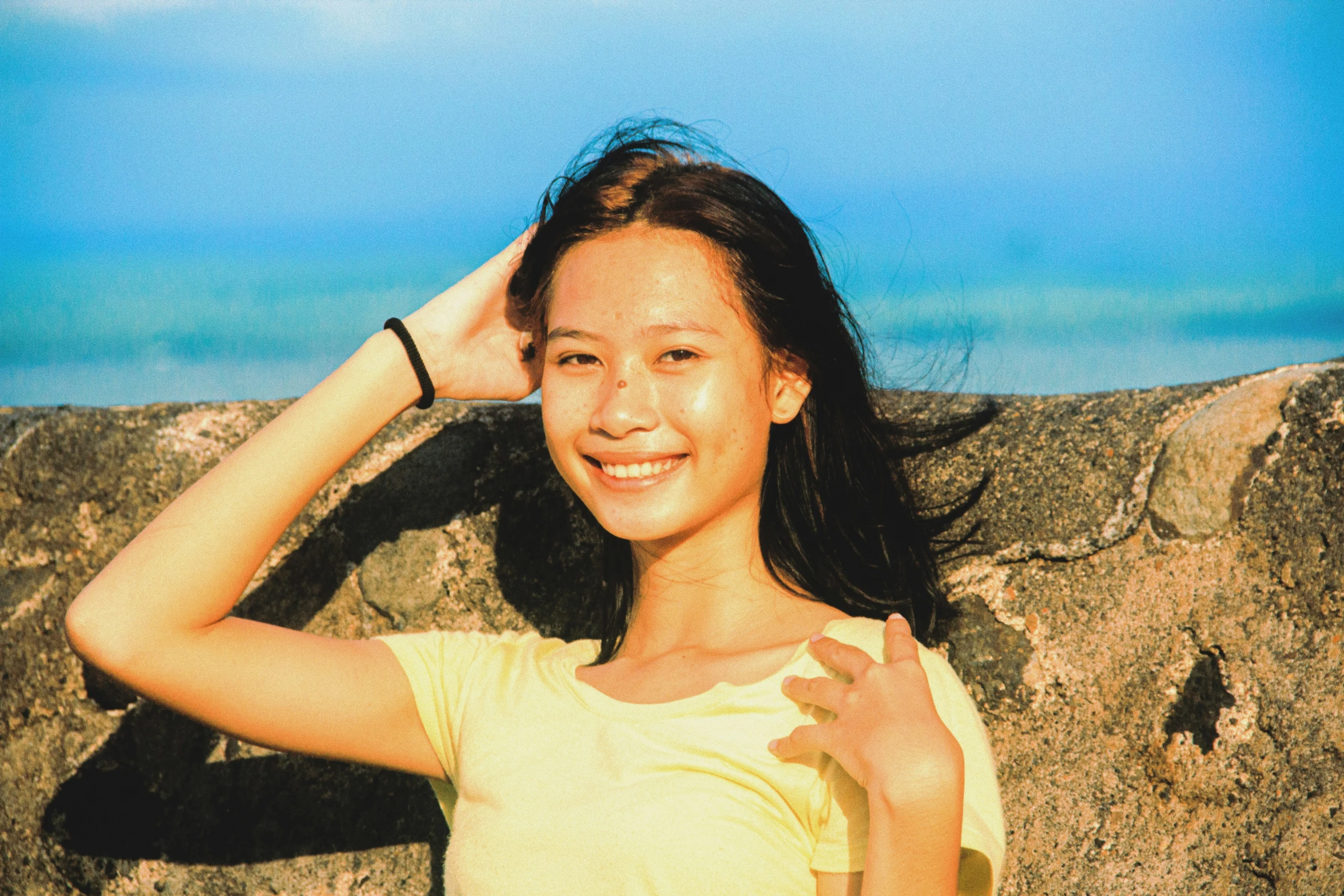 a beautiful young woman wearing a yellow shirt