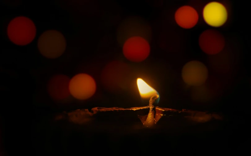 a single candle is shown in the dark