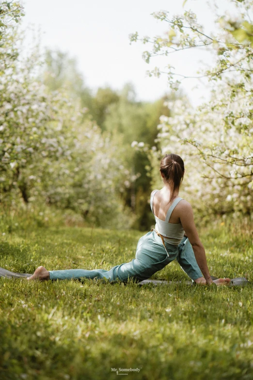 a woman sitting in a yoga position on a mat