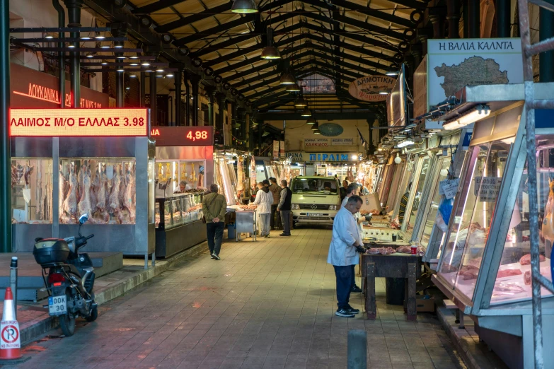 a market with people shopping and stalls in it