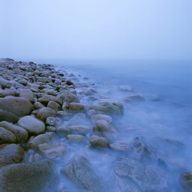 a rocky shoreline covered in water and rocks