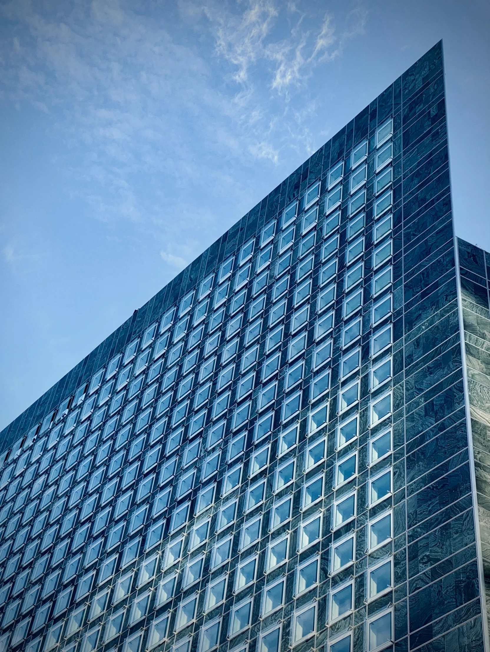 this is a tall glass building on a sunny day