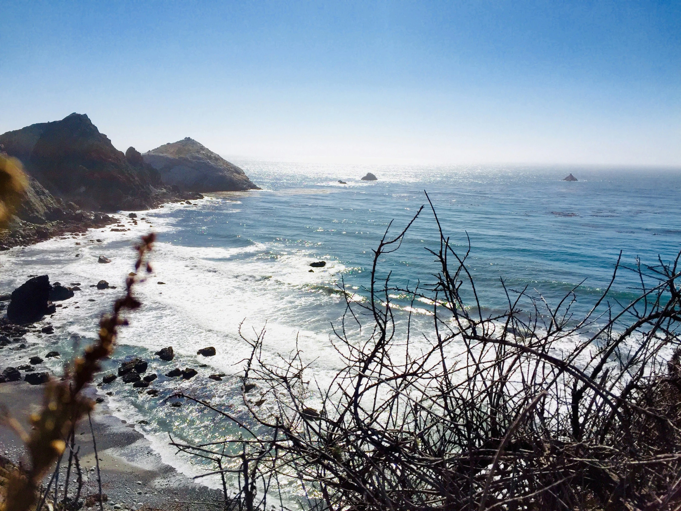 a view looking across the water to some rocky cliffs