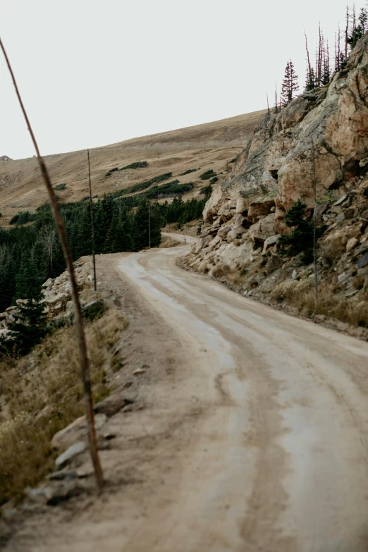 an old road surrounded by a rocky mountain