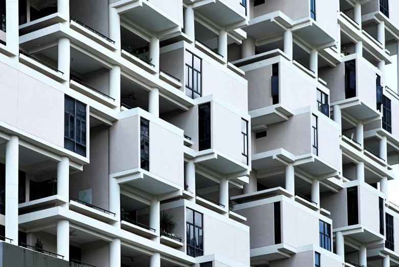 a tall white building with many balconies in the windows