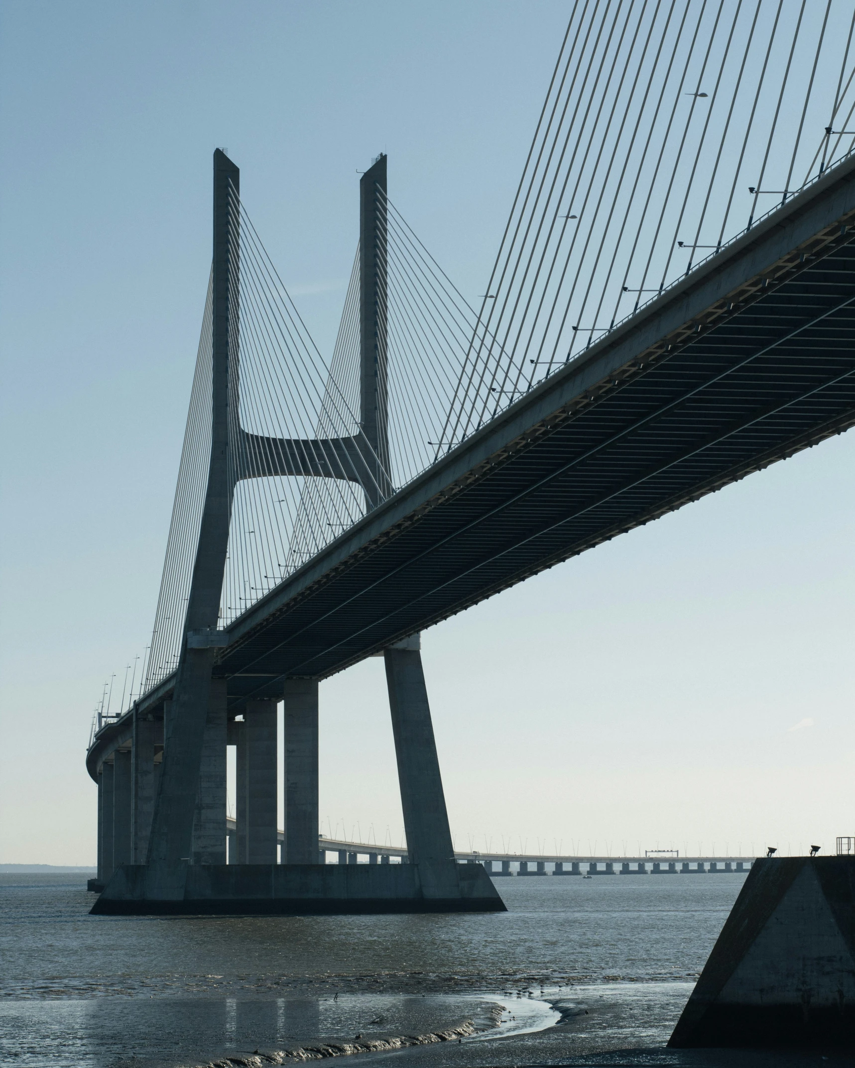 a bridge is shown with the ocean in front