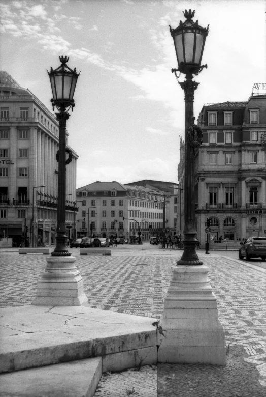 two light poles are pictured on the side of the road