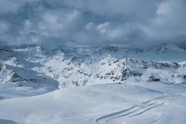 a mountain filled with lots of snow next to trees