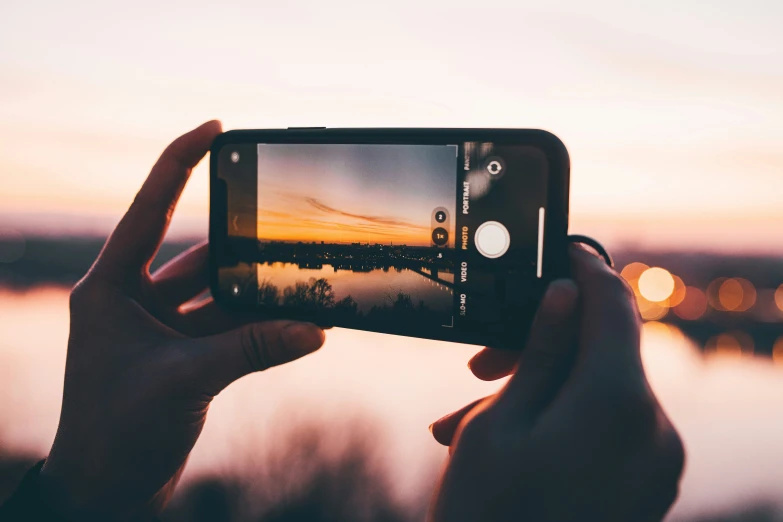 a hand holding a camera up to take a po