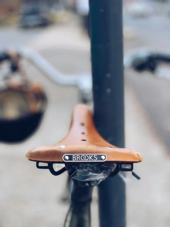 a bicycle seat attached to a tall pole