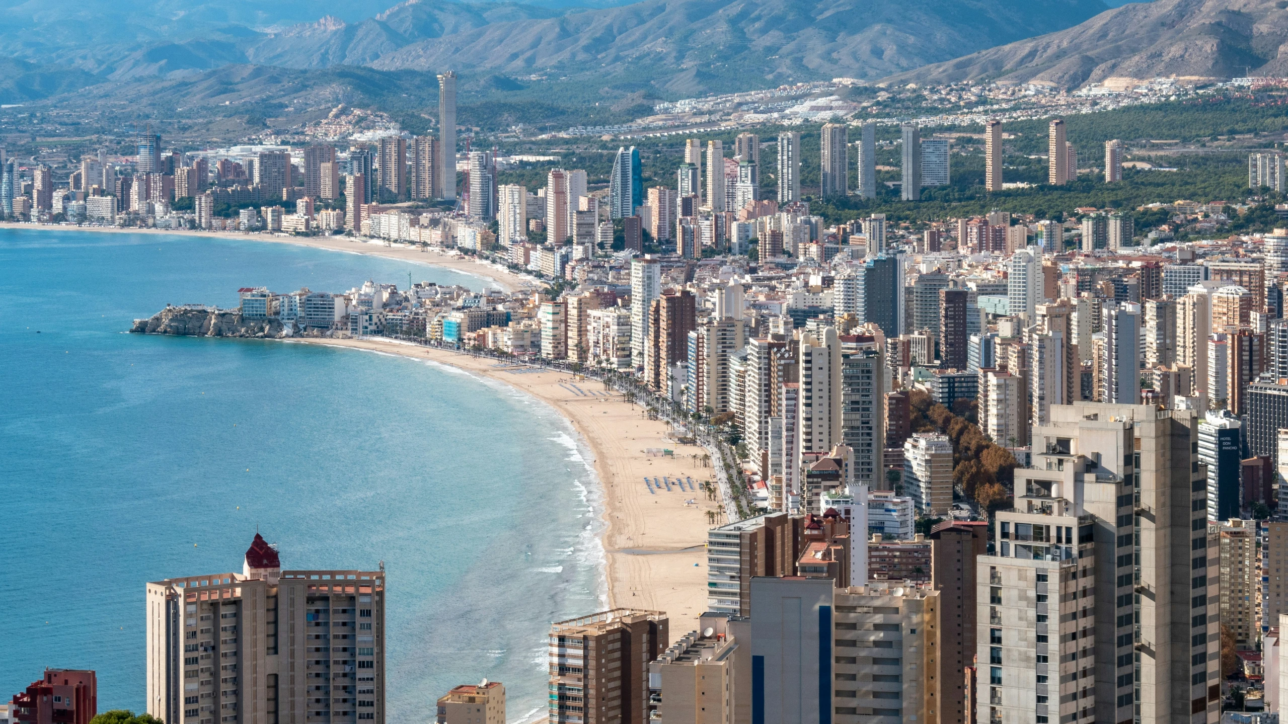 an aerial view of a beach, coastline and skyline