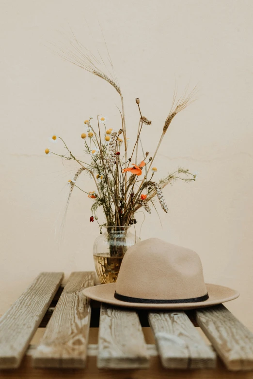 the hat and the vase are on the table